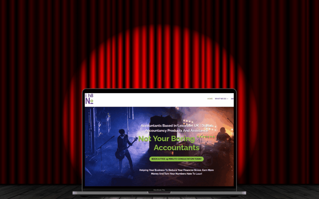 A theatre stage with a spotlight on a laptop showing the I Hate Numbers homepage to show that they do bookkeeping for arts organisations.